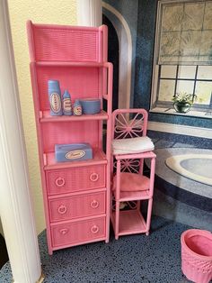 a bathroom with pink furniture and blue flooring