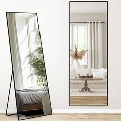 a large mirror sitting on top of a wooden floor