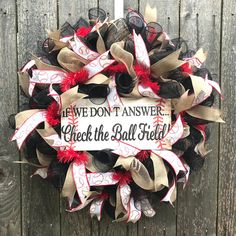 a baseball wreath that says we don't answer check the ball field