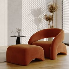 an orange chair and footstool in a room