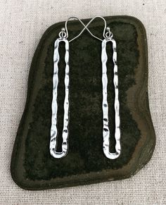 "Unique and eye catching long modern silver earrings. They are simple in design yet make a statement. These earrings are versatile and perfect for everyday wear. The earrings measure 2 3/8\" long by 3/8\" wide. They hang from simple silver ear wire hooks. Overall drop length is 2 1/2\". Made from plated silver. Thanks for stopping by! Please take a moment and visit the rest of my Etsy shop. I have many more unique jewelry designs to choose from. 🌸 Tiger Flower Jewelry 🌸 🌸 Inspired by Nature ? Modern Nickel-free Dangle Linear Earrings, Modern Silver Hypoallergenic Linear Earrings, Modern Hypoallergenic Dangle Linear Earrings, Modern Hypoallergenic Silver Linear Earrings, Modern Metal Long Drop Linear Earrings, Modern Metal Linear Earrings For Everyday Wear, Everyday Long Drop Metal Linear Earrings, Modern Metal Linear Earrings For Everyday, Metal Long Drop Linear Earrings With Ear Wire