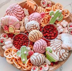 a platter filled with lots of different types of cookies and desserts on top of it