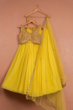 The Bumblebee Yellow Lehenga with Colored Blouse features a vibrant yellow lehenga paired with a multicolored blouse and a matching dupatta. Perfect for festive celebrations, this eye-catching ensemble blends traditional charm with contemporary style, making it ideal for weddings, festivals, and special occasions. Cheap Yellow Blouse Piece For Puja, Bridal Crop Top, Multicolored Blouse, Kaftan Kurta, Lehenga And Blouse, Kurta Lehenga, Prince Coat, Raw Silk Lehenga, Waistcoat Woman