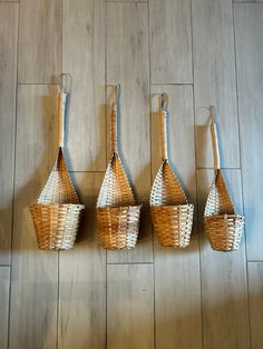 four woven baskets hanging on the wall