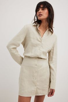 This mini dress is made of linen and features a shirt collar. It has a button closure and an elasticized waist. The mini dress has long sleeves with double button cuffs. Linen Shirt Dress, Beige Outfit, Italy Outfits, Button Up Dress, Party Dress Short, Linnet, Stylish Work Outfits, Future Fashion, Denim Jumpsuit