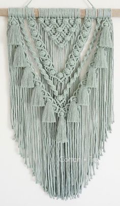 a macrame wall hanging with tassels