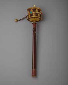 an ornate wooden pole with a gold crown on top