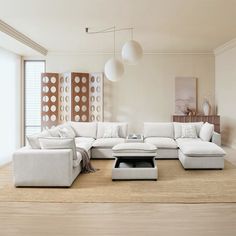 a living room filled with white furniture on top of a hard wood floor