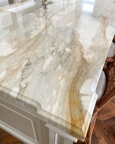 a marble counter top in the middle of a kitchen