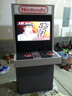 an old school video game is on display in a room with other items and tools