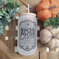 an image of some pumpkins and other things on a wooden table with the words hoccus pocus apothecar