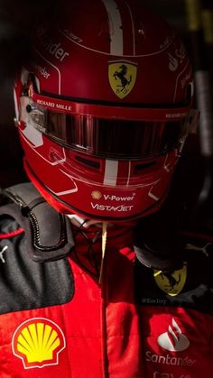 the helmet of a ferrari driver sits on display