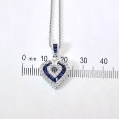 "This marvelous open heart shaped gemstone pendant necklace showcases baguette cut sapphires set in a channel setting & crafted in 14k white gold.The contemporary heart shaped pendant features bright round cut diamonds 0.50 c.t.w., color/clarity G,H-SI alternating with baguette cut sapphires 0.50 c.t.w. Enjoy a matching 14k white gold 18\" long chain with your purchase. Chain secures with lobster claw clasp. Necklace weight is 5.6 grams. For more information, contact Avital & Co Jewelry Heart-shaped Sapphire Necklace For Anniversary, Sapphire Heart Necklace For Anniversary, Sapphire Heart Necklaces For Anniversary, Fine Jewelry Diamond Heart Necklace With Gemstone, Sapphire Heart Pendant Jewelry For Anniversary, Heart-shaped Sapphire Jewelry For Formal Occasions, Heart Cut Sapphire Jewelry Gift, Heart Cut Sapphire Jewelry For Gifts, Formal Heart-shaped Sapphire Jewelry