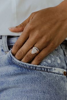 a close up of a person's hand with a ring on their finger