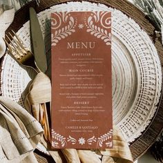 a menu sitting on top of a plate next to utensils and napkins