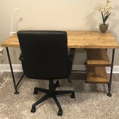 an office desk with two black chairs next to it and a potted plant in the corner