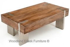 a wooden coffee table with metal legs