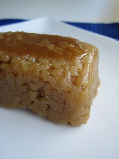 a close up of a piece of food on a plate with blue and white table cloth