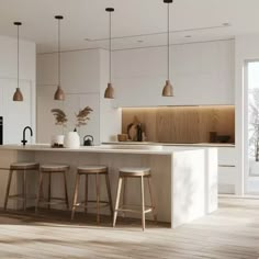 an open kitchen with three stools next to the counter and two lights hanging from the ceiling