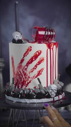 a white and red cake with blood on it