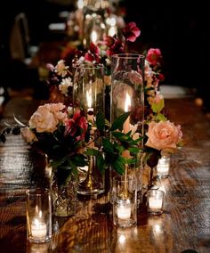 candles and flowers are arranged on the table