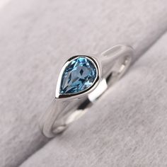 ◆ The ring is handcrafted from sterling silver and decorated with a dazzling 7*5 mm London blue topaz. It is suitable for engagement/anniversary/daily occasion. ◆ Production Description: Main stone Type: Real London blue topaz Main Stone Shape: Pear Cut Main Stone Size: 7*5 mm(0.96ct) Side stone: None Metal: 925 Sterling silver - Other options available in the drop down menu ◆ Customization: √Free for Add Engraving √Other Metal Type Available √Other Gemstones & Shapes Available √Personalization Blue Topaz Ring With Tension Setting For Promise, Anniversary Blue Topaz Teardrop Ring, Anniversary Teardrop Blue Topaz Ring, Sterling Silver Teardrop Topaz Ring For Anniversary, Anniversary Teardrop Topaz Ring In Sterling Silver, Fine Jewelry Blue Topaz Ring With Tension Setting, Blue Topaz Teardrop Promise Ring, Blue Topaz Ring With Tension Setting, Elegant Teardrop Topaz Ring In Sterling Silver