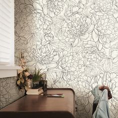 a room with a wall paper that has flowers on it