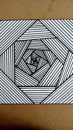 an image of a black and white drawing on paper with lines in the shape of a spiral