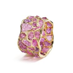 A barrel ring encrusted with brilliantly sparkling gemstones that have a truly opulent glow. They are encased in a setting of pure gold that is truly radiant in its shine and lusture.Details:Silver 925 Stones: Ruby RoughPlating: Gold 18KWidth: 11 mmBand wide: 11 mmLength: 23 mmWeight: 7.15 g Luxury Multi-stone Cubic Zirconia Gemstones, Luxury Pink Sapphire Diamond Ring With Gemstone, Elegant Multi-stone Pink Sapphire Diamond Ring, Luxury Multi-stone Cluster Diamond Ring, Luxury Multi-stone Diamond Cluster Ring, Luxury Pink Sapphire Ring With Pave Setting, Elegant Diamond Ring As Gift, Dazzling Yellow Gold Rings For Party, Dazzling Yellow Gold Party Rings