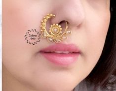 "weight: 0.1 oz Around 1\" (round) Height = 30 mm || Width = 25 mm Classic Nose Ring Antique Nose Ring Indian Bridal Traditional One Gram Jewelry Indian Nose Ring does not require a hole in the nose. This Nose Ring is pressable (no piercing is required ) and worn on the left side .. Gorgeous 24 K gold plated. This Nose ring is designed for all special occasions. it requires NO piercing , just press it and you are done. the size of the nose ring is approximately the size of a Cent. CARE: Keep jew Adjustable Traditional Nose Rings For Wedding, Gold Nose Studs For Wedding, Silver Hoop Nose Ring For Wedding, Wedding Hoop Septum Ring, Temple Jewelry Style Nose Rings For Festivals, Gold Nose Rings For Wedding Festivities, Gold Hoop Nose Rings For Wedding, Temple Jewelry Chandbali Nose Rings For Wedding, Festive Chandbali Nose Ring For Weddings