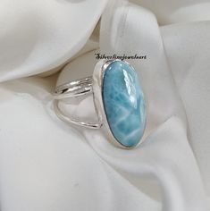 Natural Larimar Ring, Spilt Band , Gemstone Ring, 925 Sterling Silver, Handmade Ring, Gift For Her, Big Oval Gemstone, Blue Larimar, Gift, Material: 925 Solid Sterling Silver Gemstone: Larimar Stone Shape: Oval This One of a kind ring is adorned with beautiful Larimar Gemstone in sterling silver band. About gemstone-Larimar is known as Dolphin stone .Larimar is a crystal of serenity, clarity ,radiating healing and love energy. As a Water element stone Larimar cools hot tempers, calms fear, relie Big Stone Ring, Larimar Ring, Larimar Rings, Larimar Jewelry, Larimar Stone, Sterling Silver Bands, Gemstone Ring, Rings Statement, Sterling Silber