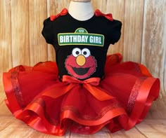 a black birthday girl shirt with an orange tutu and red ribbon around the bottom