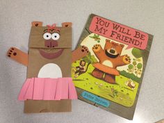 two children's books on a table, one is brown and the other is pink