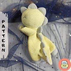 a crocheted yellow stuffed animal sitting on top of a table