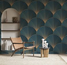 a chair and table in front of a wall with an art deco pattern on it