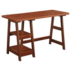 a wooden desk with two shelves on the bottom and one shelf below it, against a white background