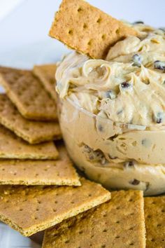 crackers and dip in a bowl with cookies on the side