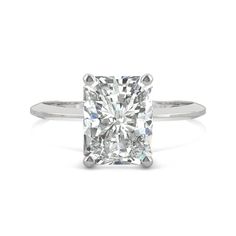 a cushion cut diamond engagement ring on a white background