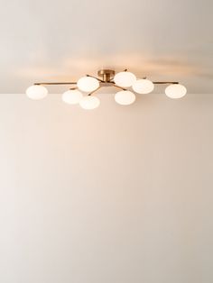 an overhead light fixture in a room with white walls and flooring on the side