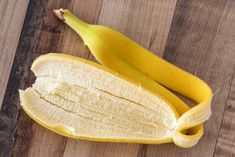 a peeled banana sitting on top of a wooden table