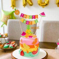 a birthday cake decorated with fruit and decorations