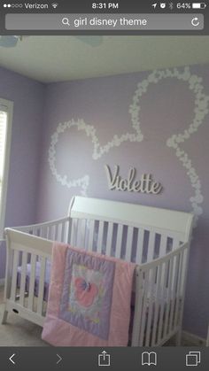 a baby's room painted in purple and white with the name violet on the wall