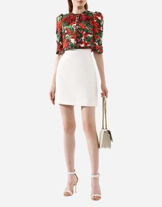 This snow-white skirt from Domenico Dolce and Stefano Gabbana's autumn-winter collection is crafted with soft cotton features a delicate floral jacquard motif. The high-waisted design enhanced by handcrafted embroidery, evoking Sicilian bridal tradition. Pair it vibrant cropped jacket matching sandals for chic elegant look. Bridal Traditions, Short Loungewear, Floral Jacquard, White Skirt, Cropped Jacket, Suits Coats, White Skirts, Coat Dress, Winter Collection