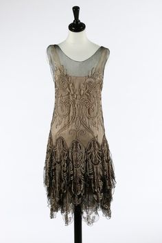 A Callot Soeurs couture black tulle and pearl beaded flapper dress, 1927. the matching rose-pink satin slip with printed gold on ivory silk label 'Callot Soeurs, Paris, Hiver, 1927-28, Nouvelle Marque Deposee' and numbered in ink '2741', the transparent tulle adorned with pink metal and pearl beaded arabesques with gold stem-stitch tendrils, the skirt falling in elaborate beaded petal-like tiers - See more at: http://kerrytaylorauctions.com/one-item/?id=56&auctionid=401#sthash.SiN357SQ.dpuf Stem Stitch, Beaded Flapper Dress, Roaring 20's