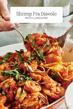 shrimp with linguine and tomato sauce in a white bowl being lifted by a fork