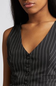 A cutout at the waist lends a faux two-in-one illusion to this pinstriped minidress designed with a playfully pleated skirt. 34" length (size medium) Front button closure; hidden side-zip closure V-neck Sleeveless Front welt pockets Lined 100% polyester Hand wash, line dry Imported