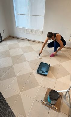 a woman is cleaning the floor with a mop