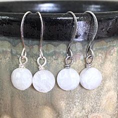 "Simple, elegant white earrings, perfect for a wedding or everyday wear.  White Moonstone 8 mm faceted coins that have a hint of sparkle.  Suspended from stylish tall nickel free ear wires in bright and brushed silver.  1\" drop from the bend and will come with plastic earring backs." Boho Charm Bracelet, Keshi Pearl Earrings, Black Tourmaline Bracelet, Small Drop Earrings, Blue Drop Earrings, June Birthday, White Pearl Earring, Plastic Earrings, Handmade Jewelry Earrings