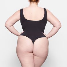 The Smoothing Bodysuit is the perfect everyday essential for light smoothing and support for your waist. Features a double scoop neck and a thong back that makes it seamless under clothing. | SKIMS Thong Bodysuit | Black | Soft Smoothing Seamless Bodysuit Black, Tights Outfit, Tan Skin, Fall Shopping, Womens Bodysuit, Black Bodysuit, Everyday Essentials Products, Onyx, Scoop Neck