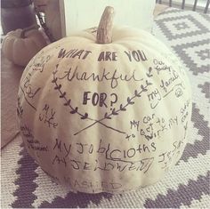 a white pumpkin with writing on it